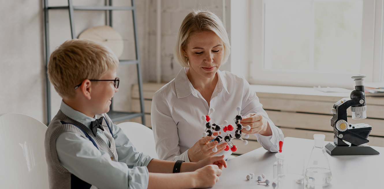 Female science tutor in Ventura studying chemistry with student